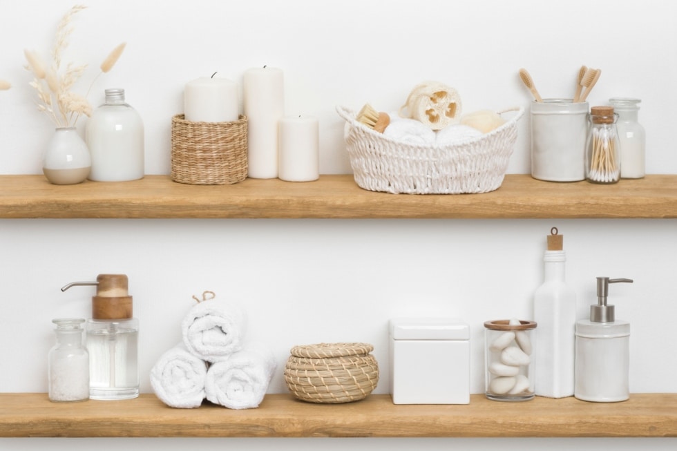 Body care cosmetics with spa accessories arranged on wooden shelves